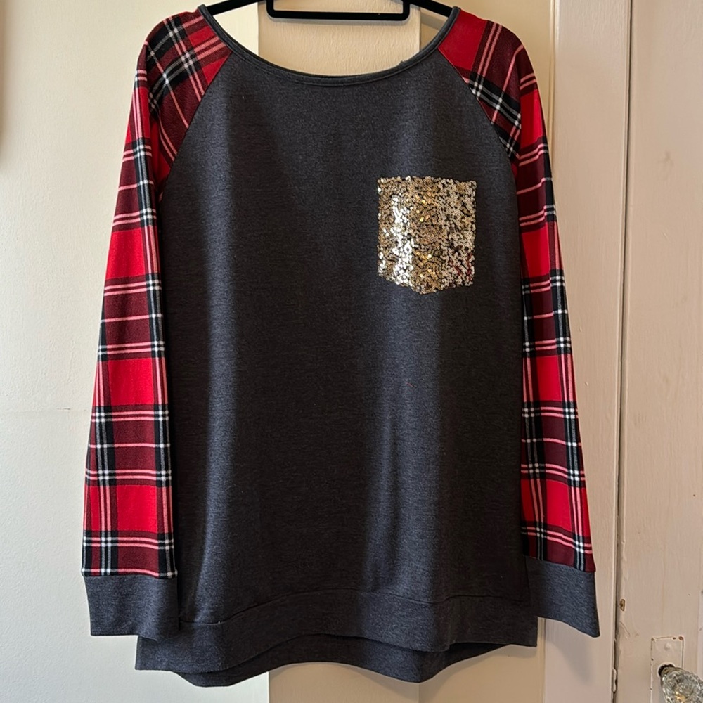 Grey shirt with red white black plaid sleeves with sparkly pocket